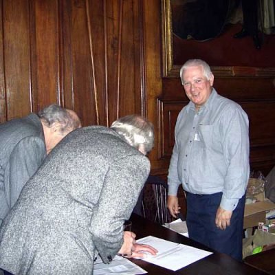 Dick Warren with 2 members bowing and pledging allegiance (or signing in)